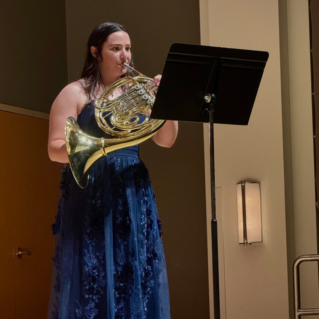 Erin Wilson performing french horn on stage for her CSU Senior recital
