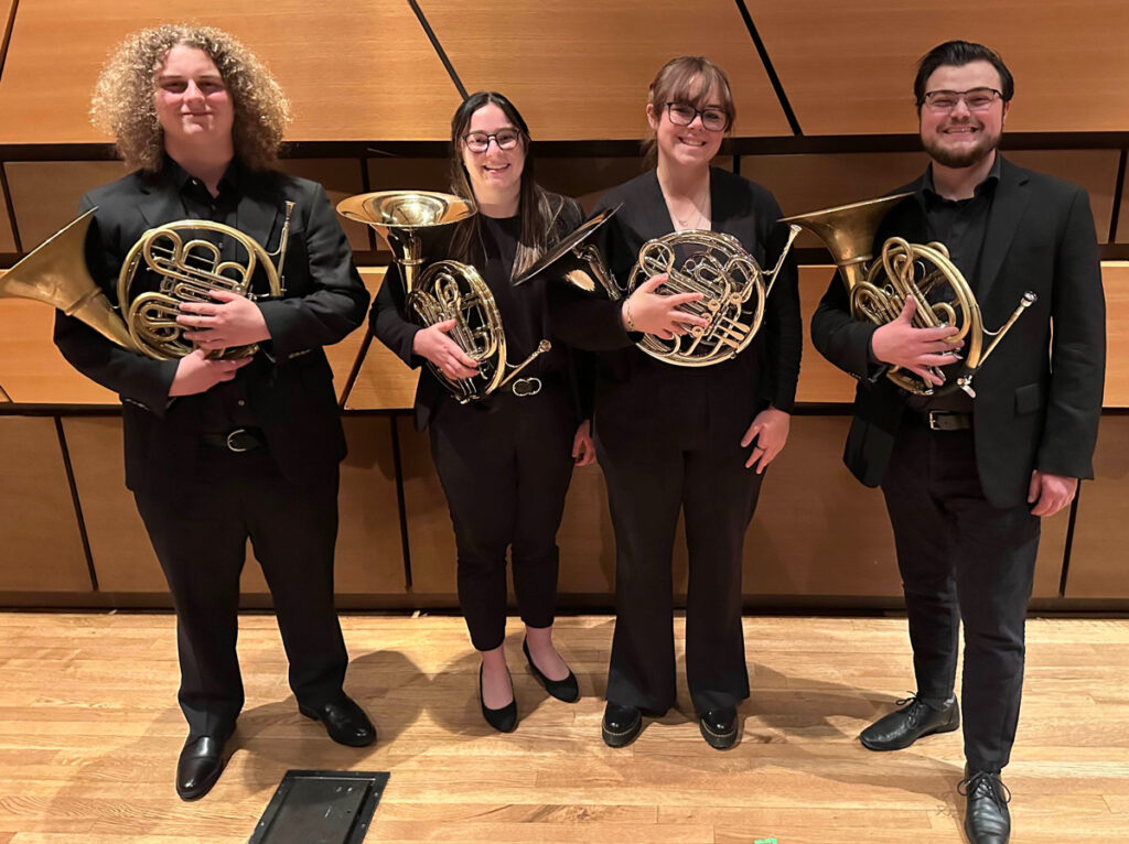 Erin Wilson with 3 other French Horn players